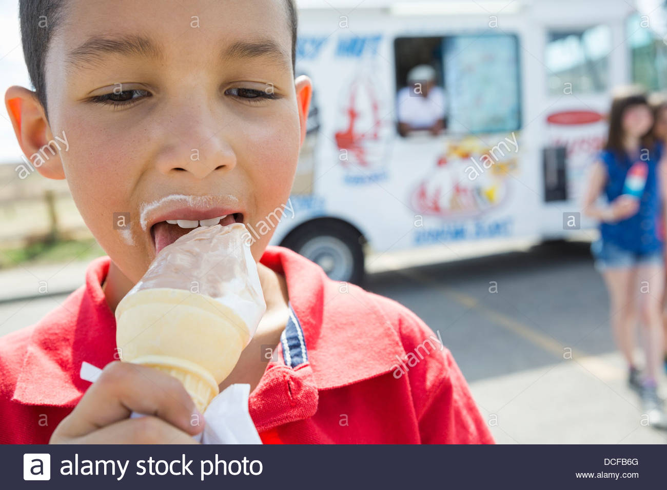 Close-up boy eating ice cream cone Stock Photo
