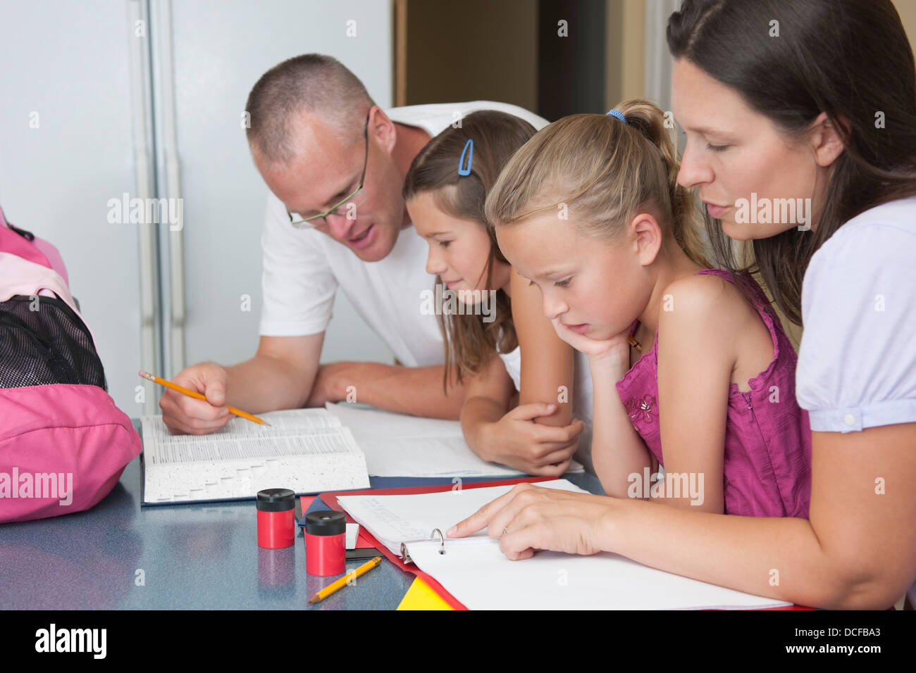 Parents Helping Their Children With Their Homework Stock Photo - Alamy