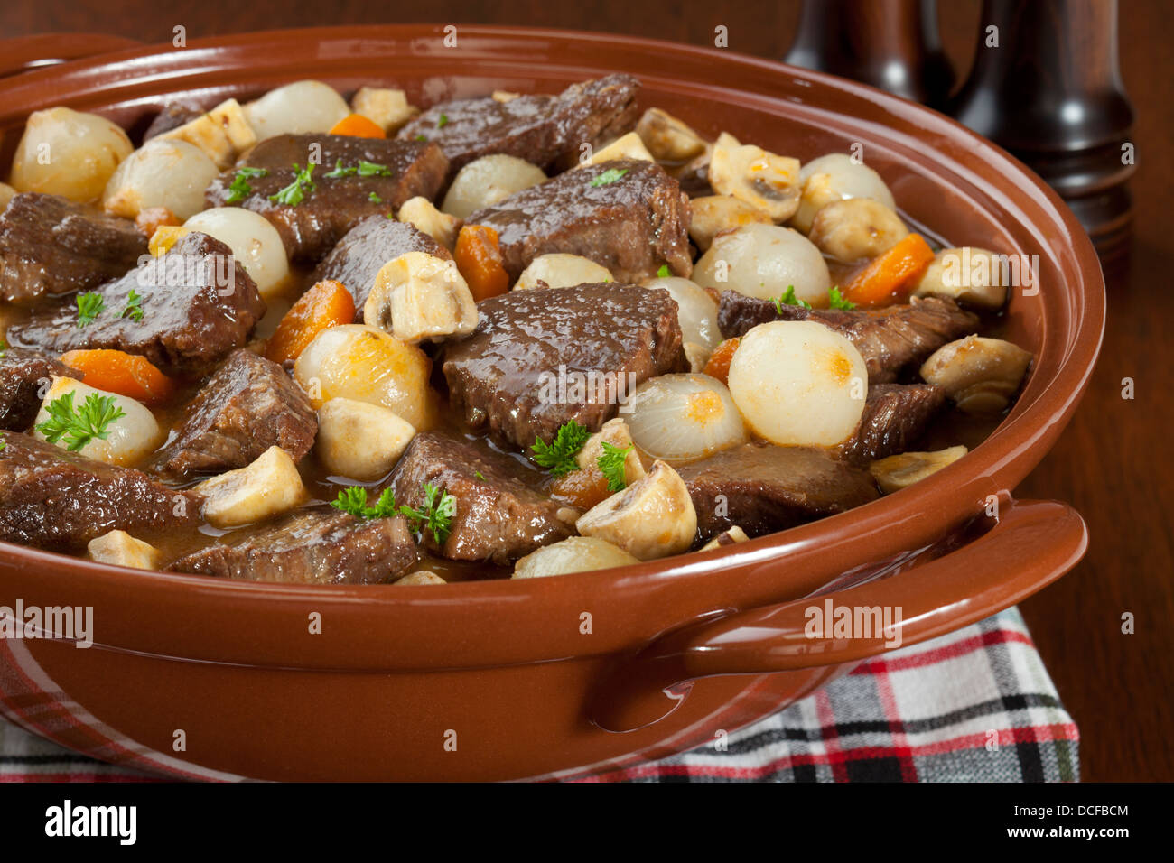 Beef Bourguignon - classic French stew, beef bourguignon, beef cooked in red wine with onions, mushrooms, bacon and carrots. Stock Photo