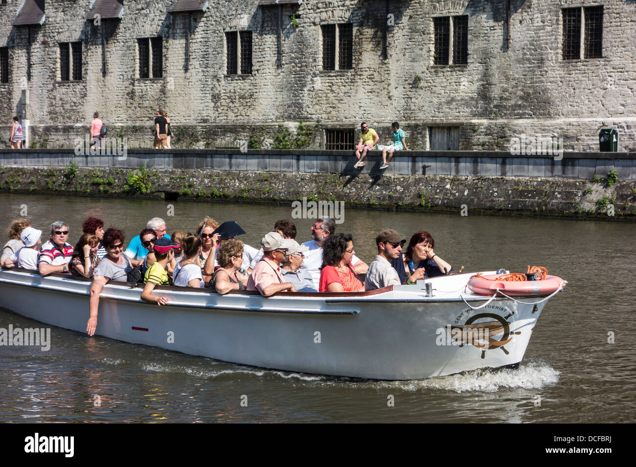 Tourists in boat on the river Leie / Lys during sightseeing trip looking at  the Groot Vleeshuis / Big Butchery in Ghent, Belgium Stock Photo - Alamy