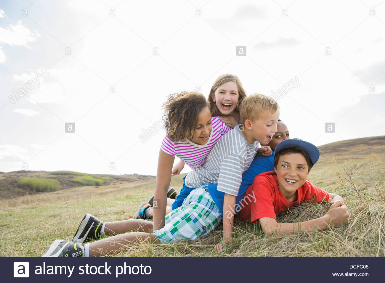 Playful schoolchildren playing outdoors Stock Photo