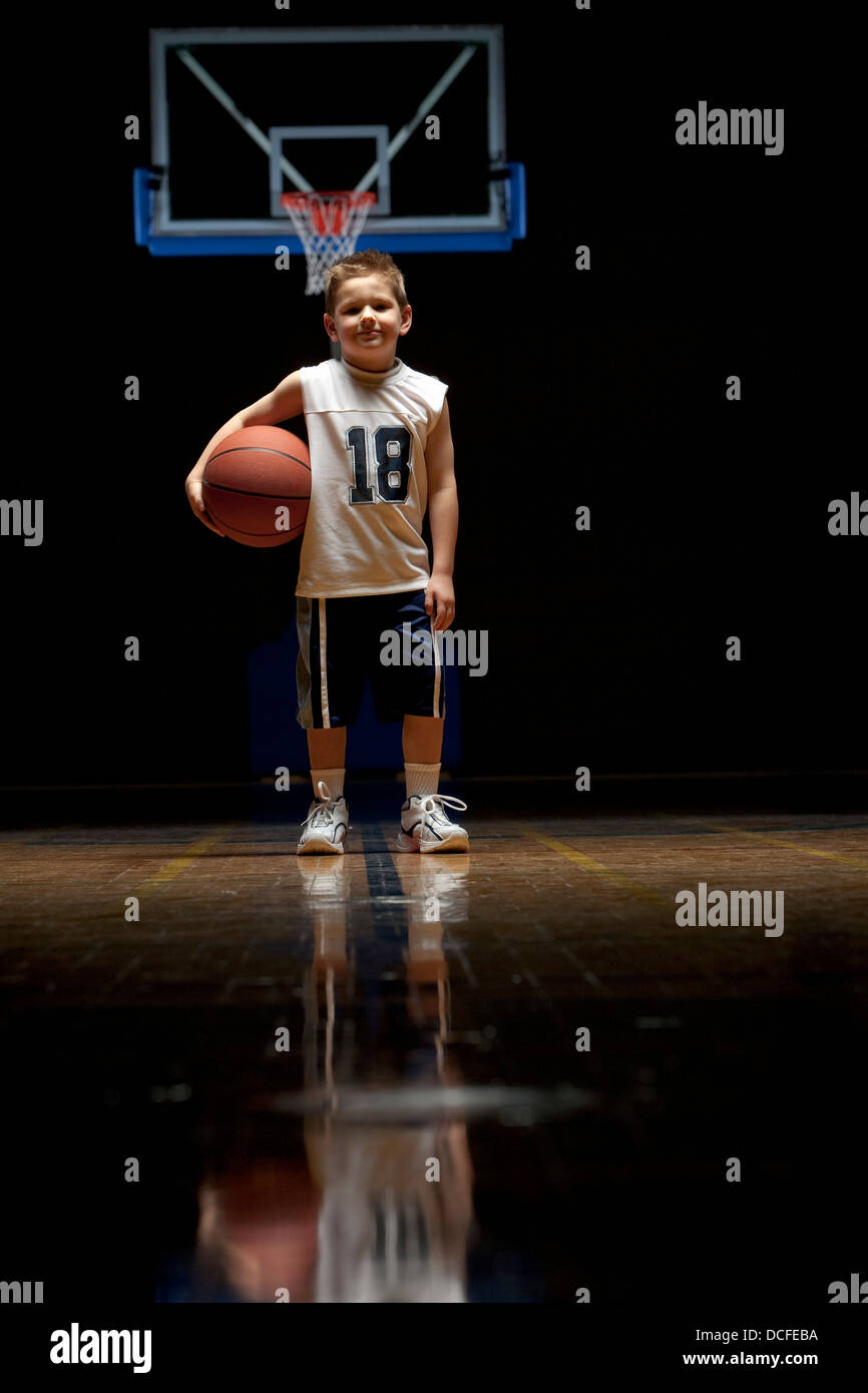 Young Boy Standing On Basketball Court Stock Photo - Alamy