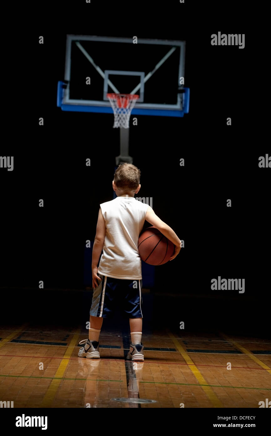 Young Boy Standing On Basketball Court Stock Photo - Alamy