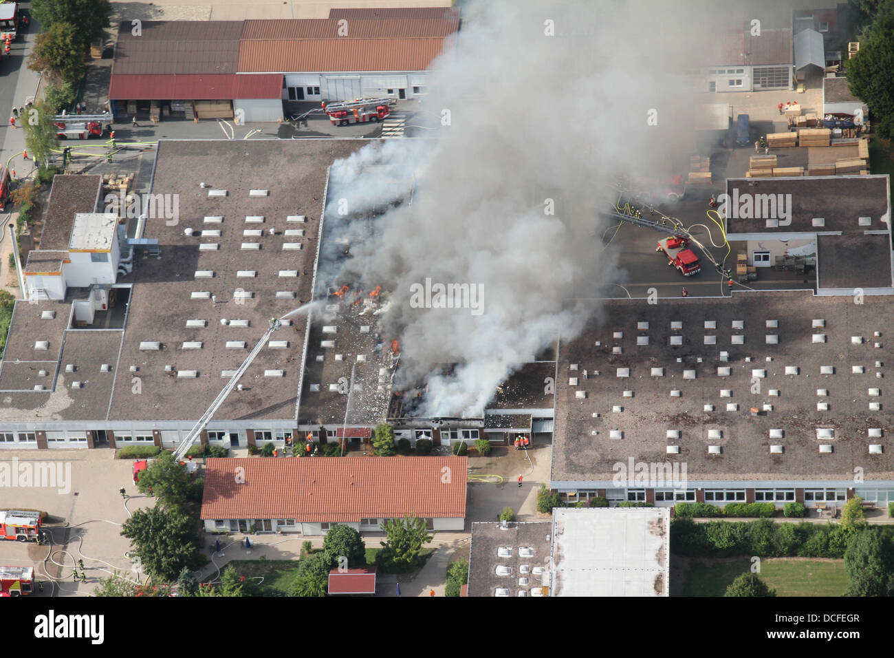 Dassel, Germany. 16th Aug, 2013. Dense smoke rises from a building of