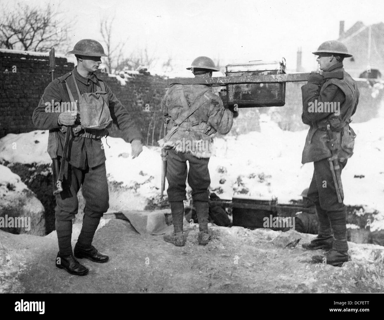 Great War. WW1 Soldiers prepare to carry rations up to the front line trenches on a snowy winters day. Stock Photo