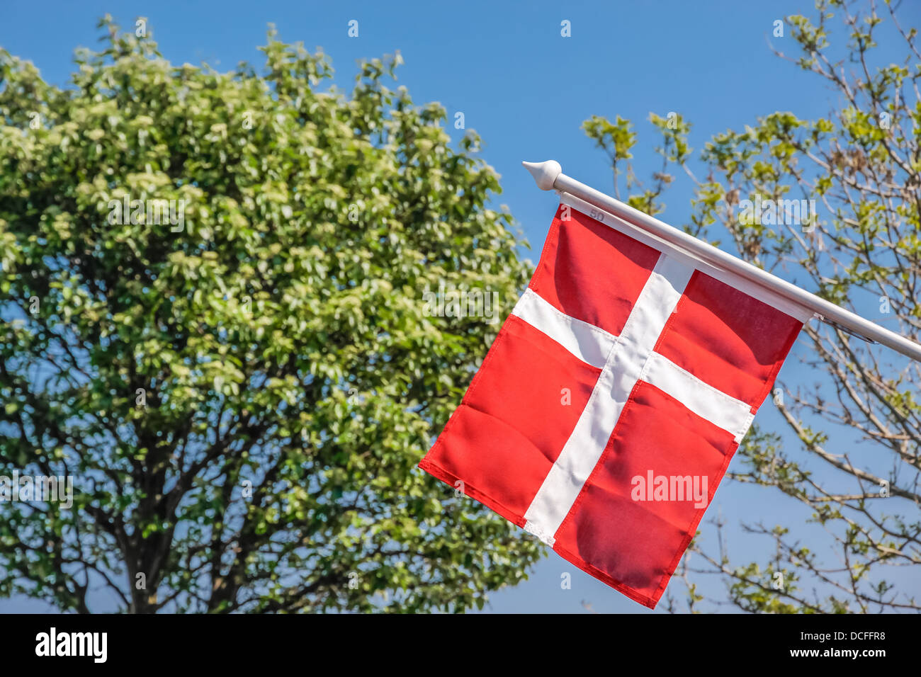 Danish flag with a green tree in Gudhjem on Bornholm, Denmark Stock Photo