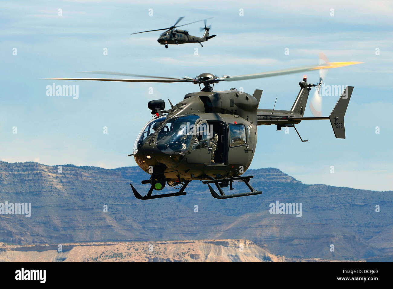 US Army UH-72 Lakota helicopter flies along with a UH-60 Black Hawk helicopter July 29, 2013 over Grand Junction, CO. Stock Photo