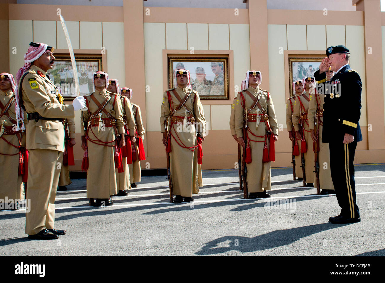 US Chairman of the Joint Chiefs Gen Martin Dempsey salutes the Jordanian Honor Guard after a pass and review ceremony August 14, 2013 in Amman, Jordan. Stock Photo