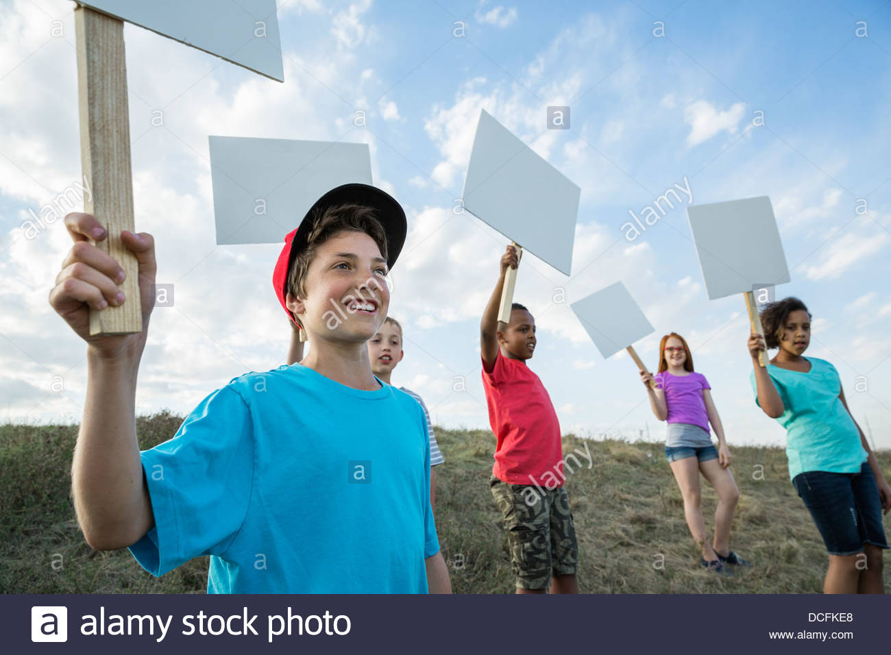 Boys holding sign hi-res stock photography and images - Alamy