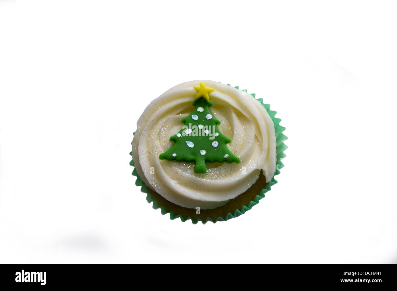 Single cup cake with Christmas tree design, from above, cut out. Stock Photo