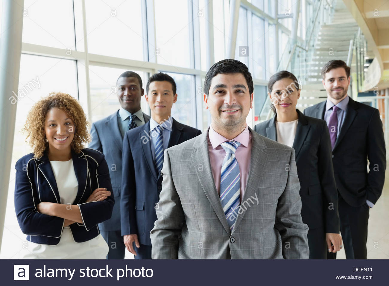 Confident businessman with his team Stock Photo - Alamy
