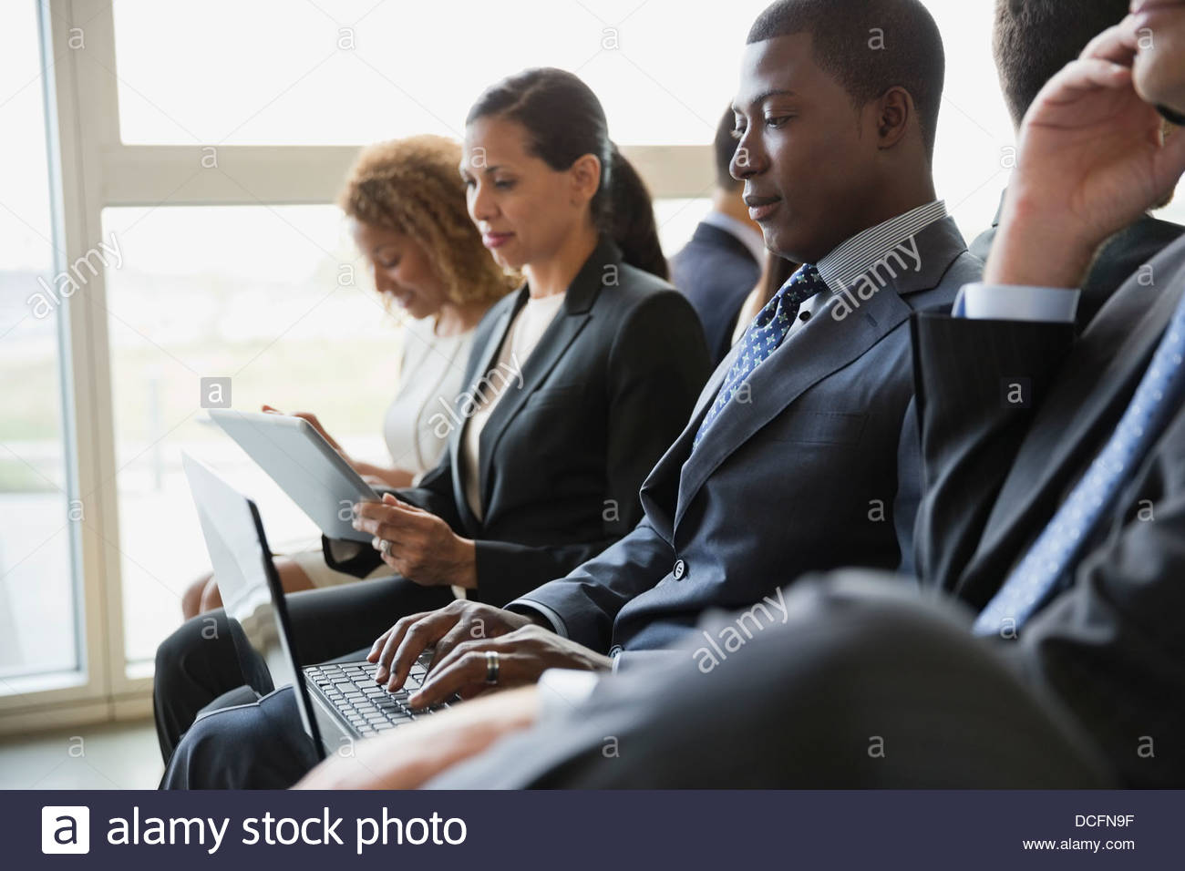 Group of business people using smart devices Stock Photo