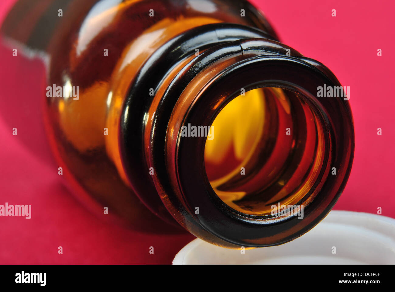a brown pill bottle and some pills Stock Photo