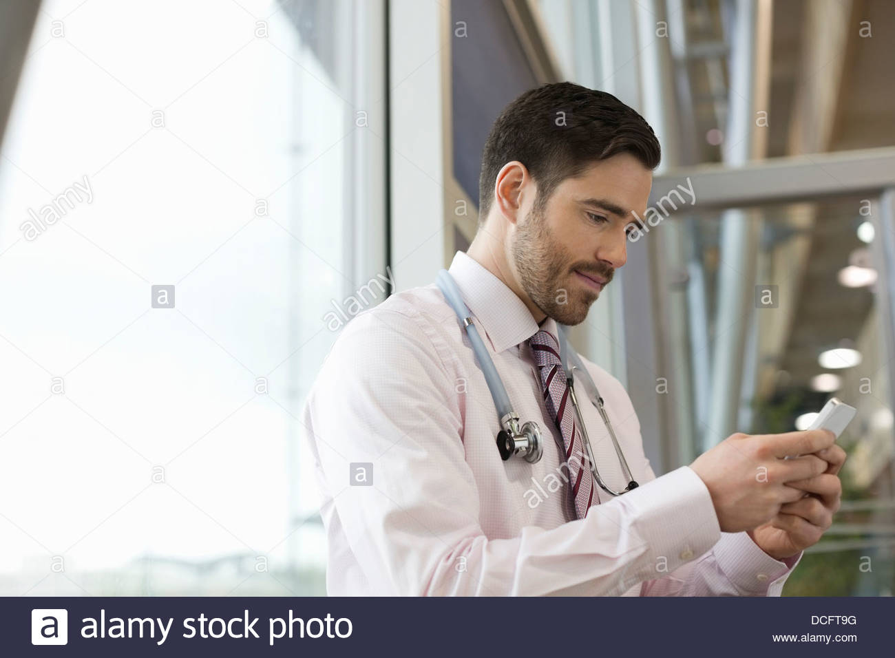 Doctor using smart phone Stock Photo