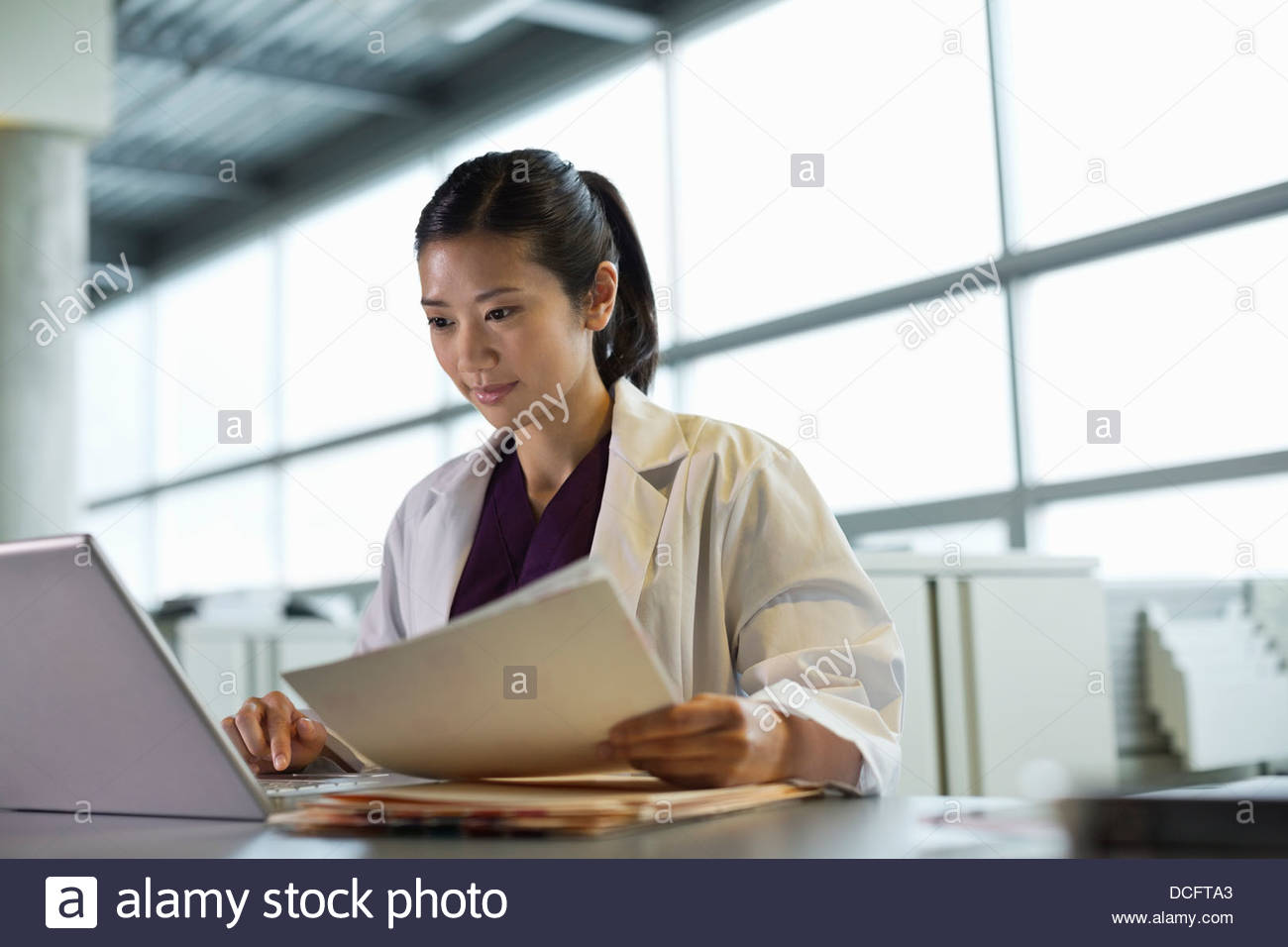 Medical professional using laptop Stock Photo Alamy