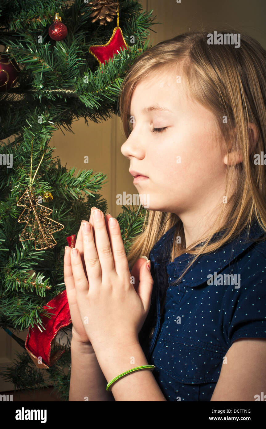 Child praying at Christmas Stock Photo - Alamy