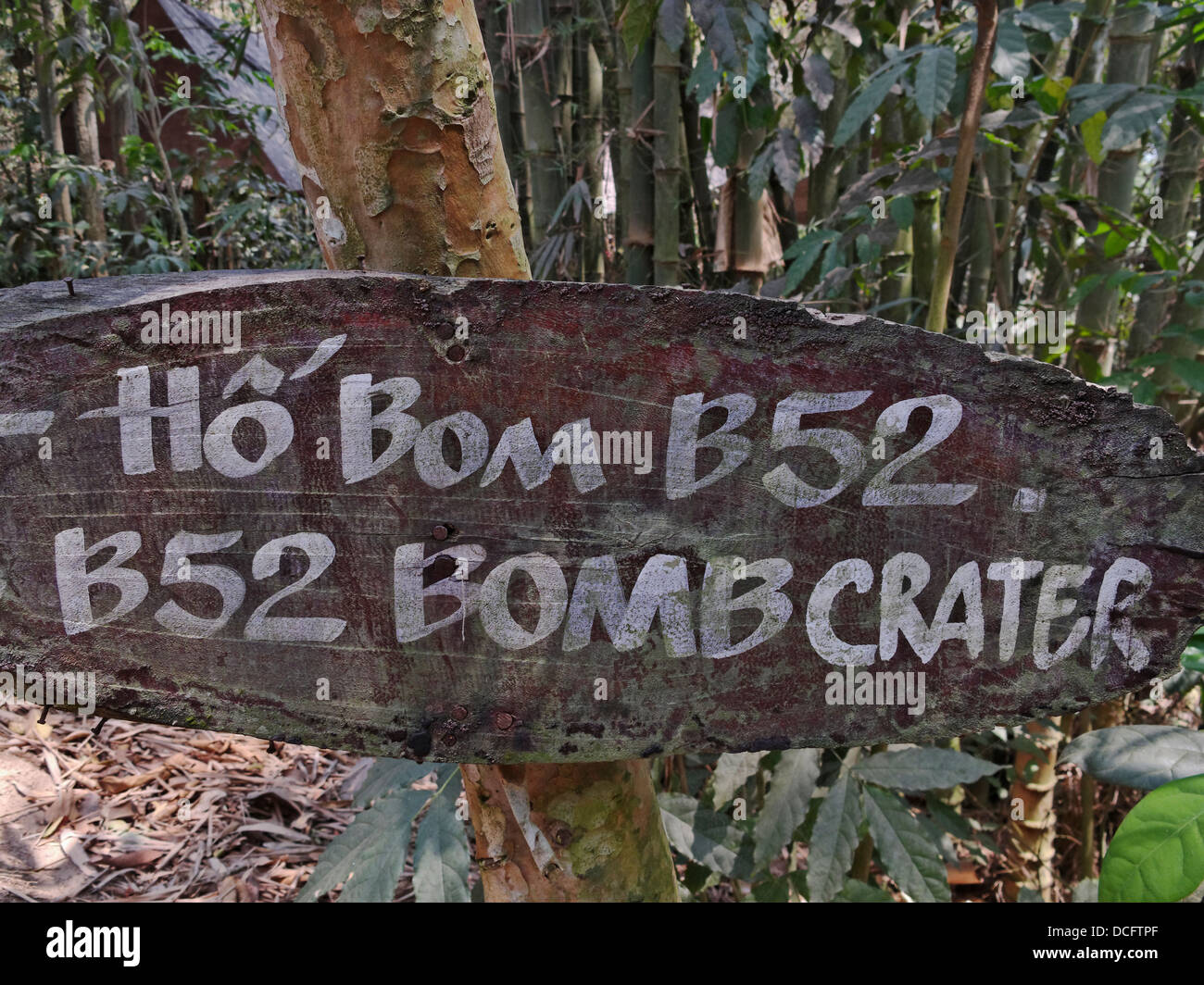 A sign indicating a bomb crater made by a USAF B-52 bomber during the Vietnam War. Cu Chi Tunnels, Saigon, Vietnam. Stock Photo