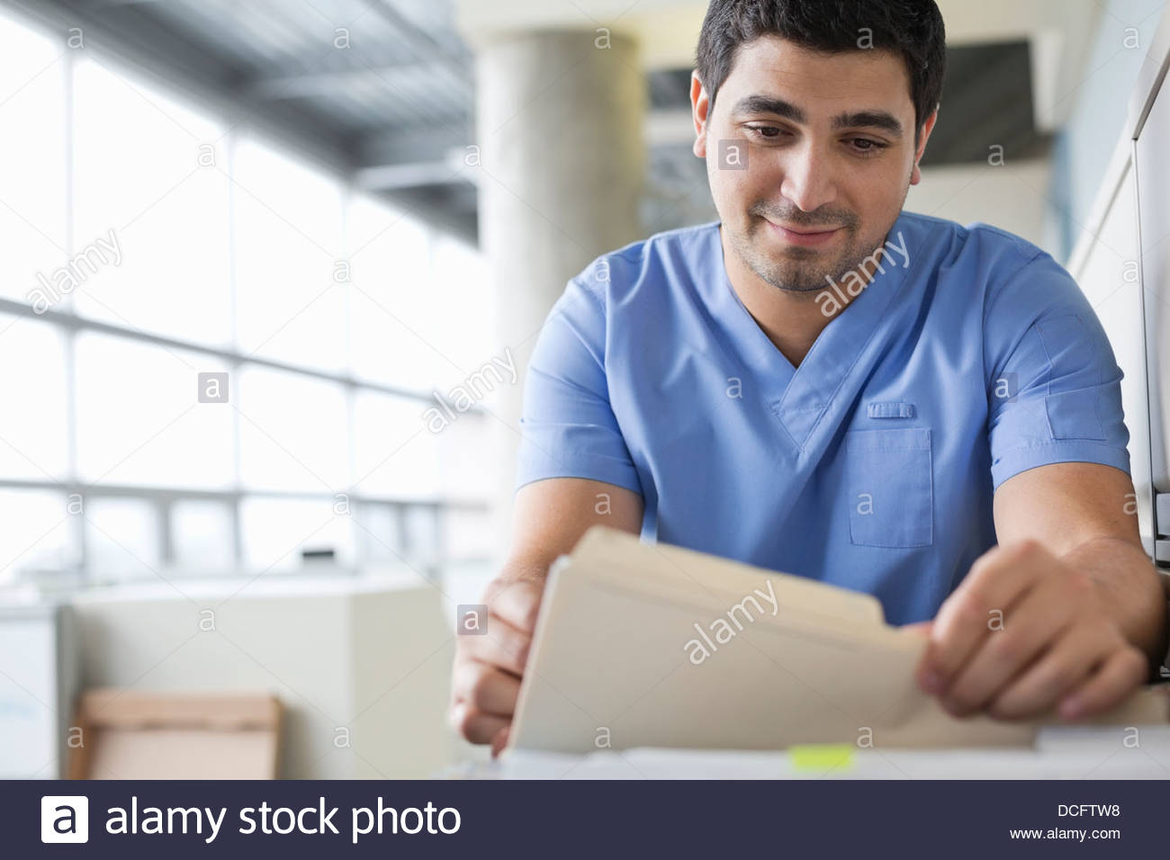 Medical professional looking through filing Stock Photo Alamy