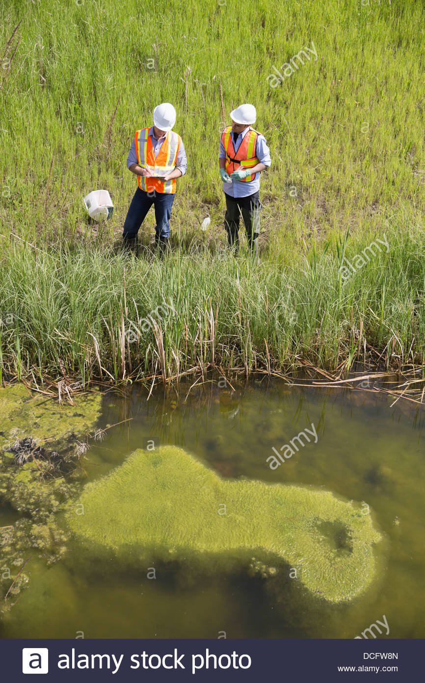 High angle view of ecologists working near riverbank Stock Photo