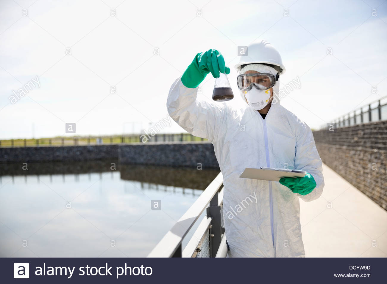 Technician examining water sample Stock Photo