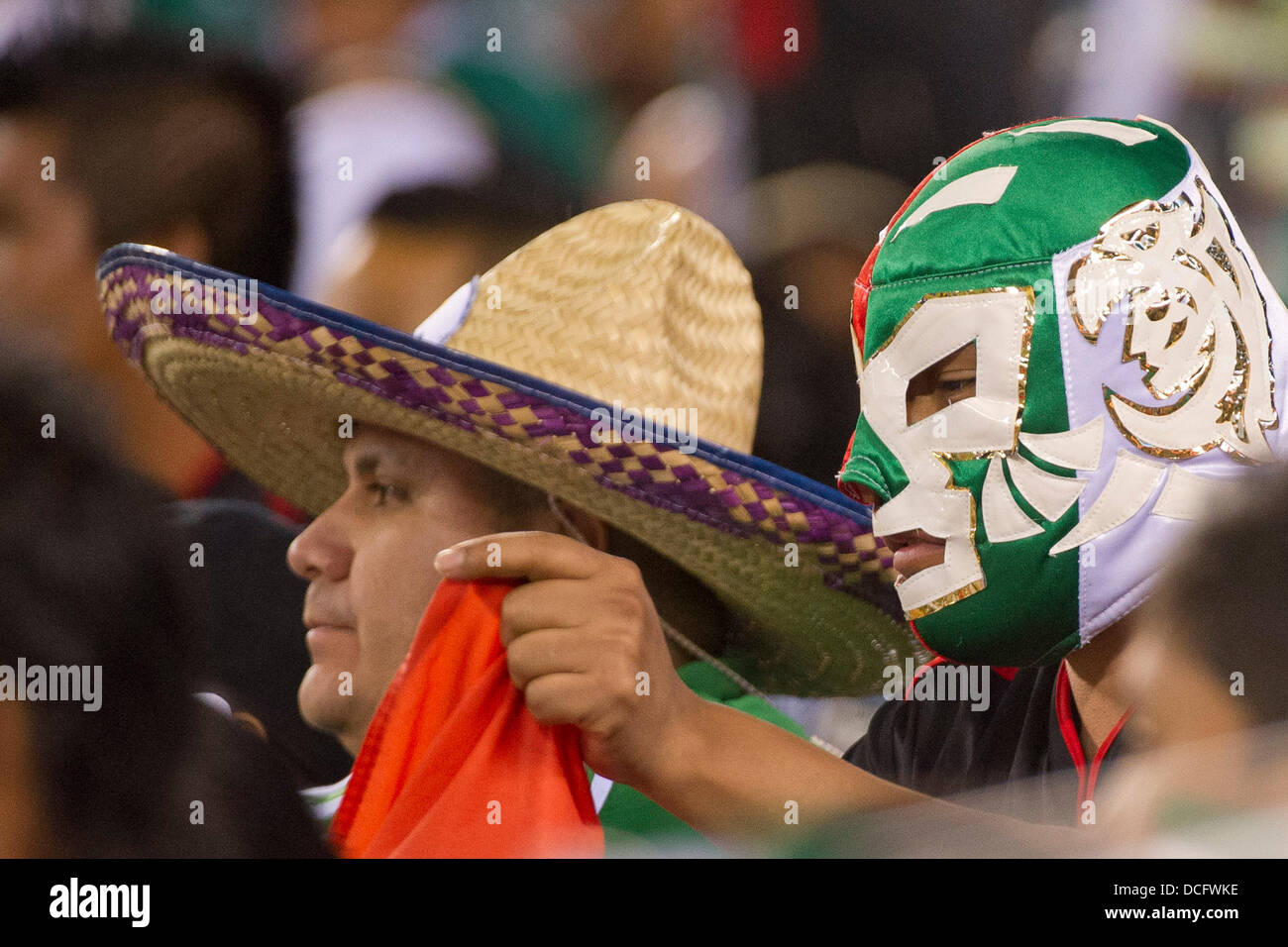 Aug. 14, 2013 - East Rutherford, New Jersey, U.S - August 14, 2013: A man in a sombrero and a man in a Mexican aztec mask look on during the International friendly match between Mexico and Ivory Coast at Met Life Stadium, East Rutherford, NJ. Mexico defeated Ivory Coast 4-1. Stock Photo