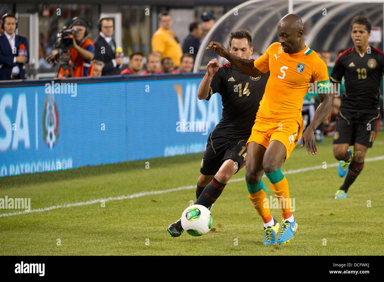 Aug. 14, 2013 - East Rutherford, New Jersey, U.S - August 14, 2013: Ivory Coast National Team defender Didier Zokora (5) looks to take the ball from Mexico National Team midfielder Christian Gimenez (14) during the International friendly match between Mexico and Ivory Coast at Met Life Stadium, East Rutherford, NJ. Mexico defeated Ivory Coast 4-1. Stock Photo