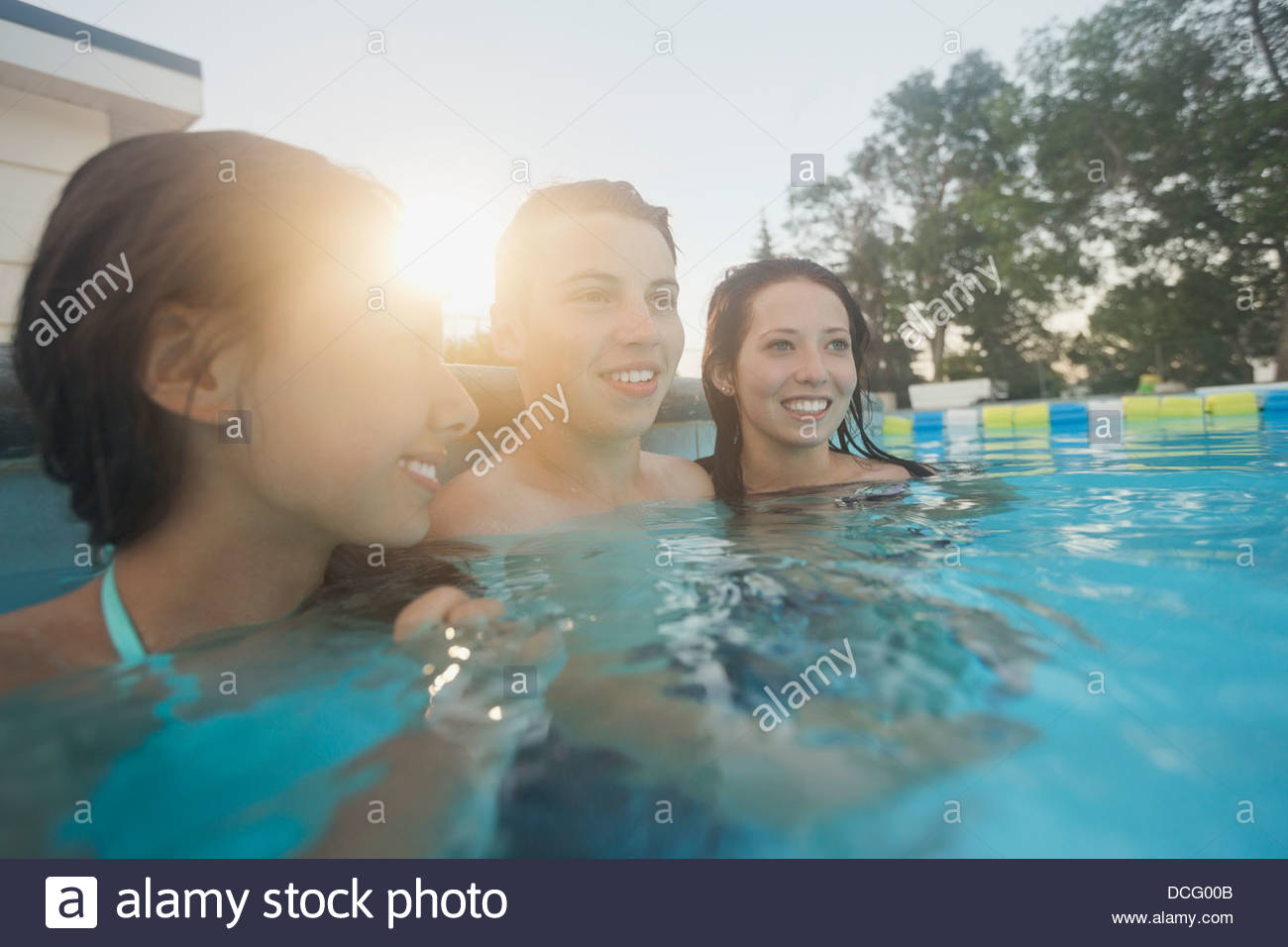 Teenage friends in swimming pool Stock Photo
