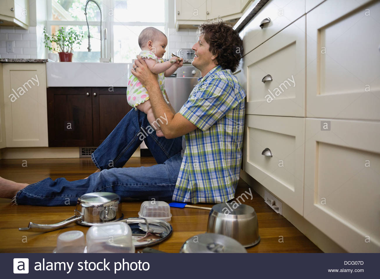Profile shot of father and baby girl in kitchen Stock Photo