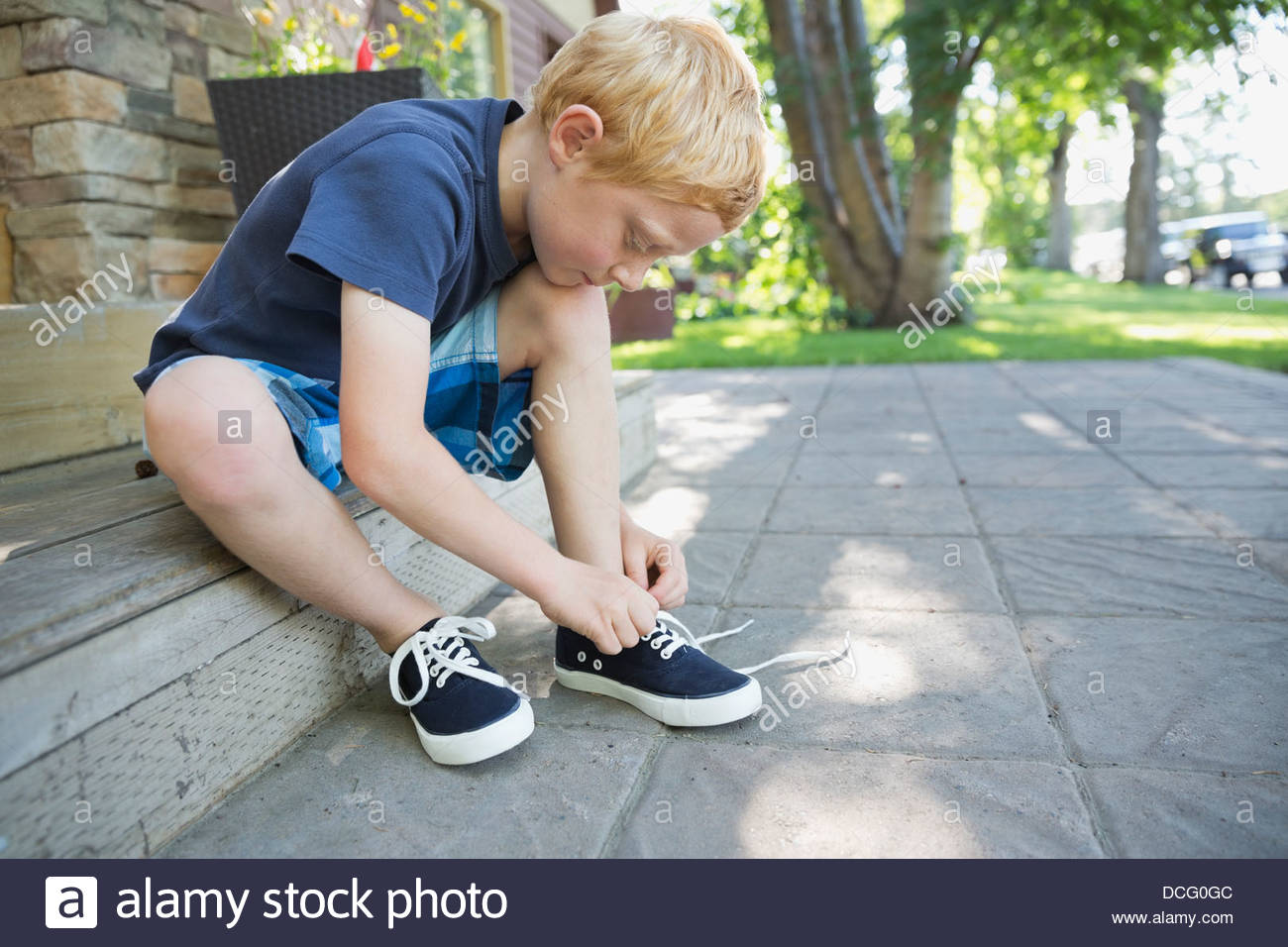 Boy tying shoe hires stock photography and images Alamy