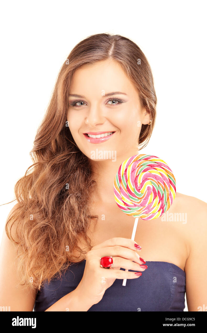 Beautiful female holding a lollipop and looking at camera Stock Photo