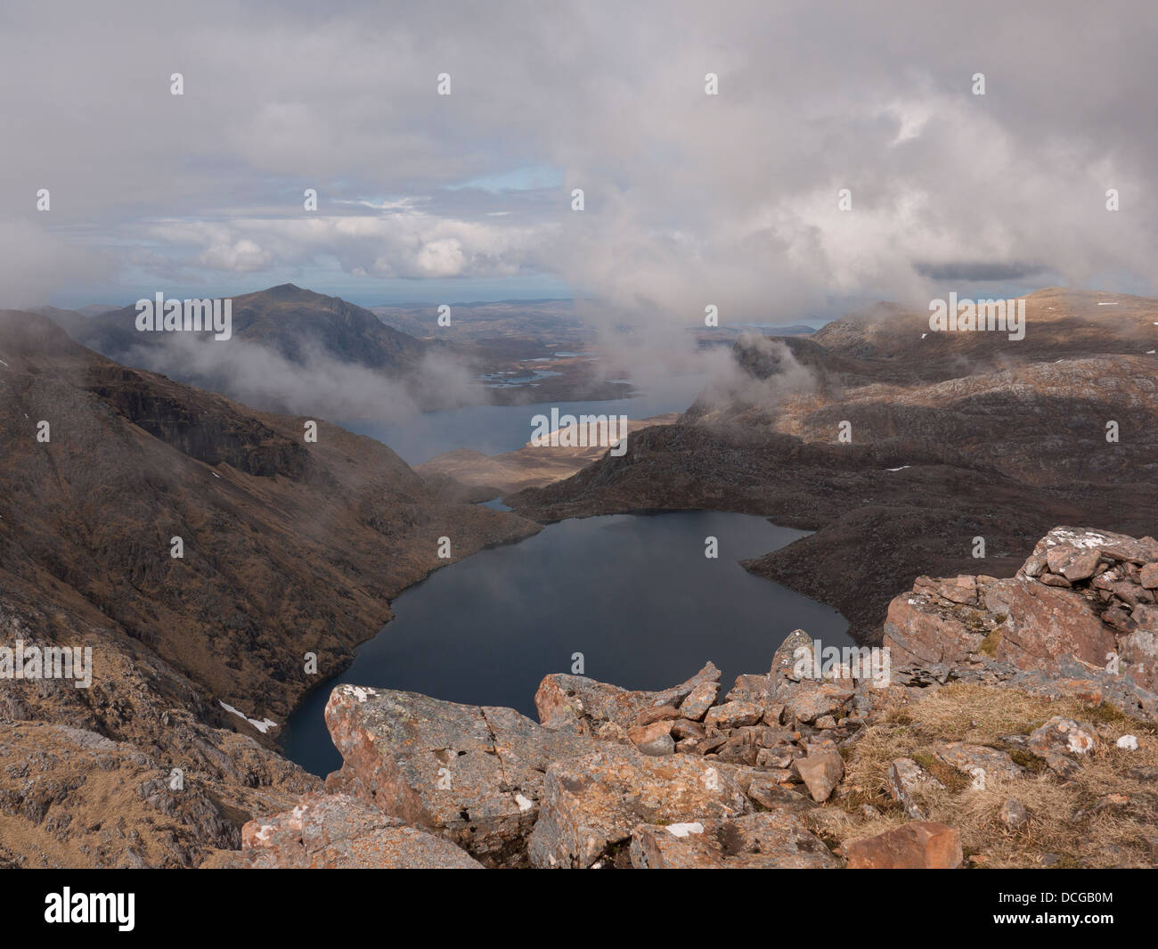 Summit view from Ruadh Stac Mor with Fuar Loch Mor below and mountain Beinn Airigh Charr in the distance, Scotland UK Stock Photo