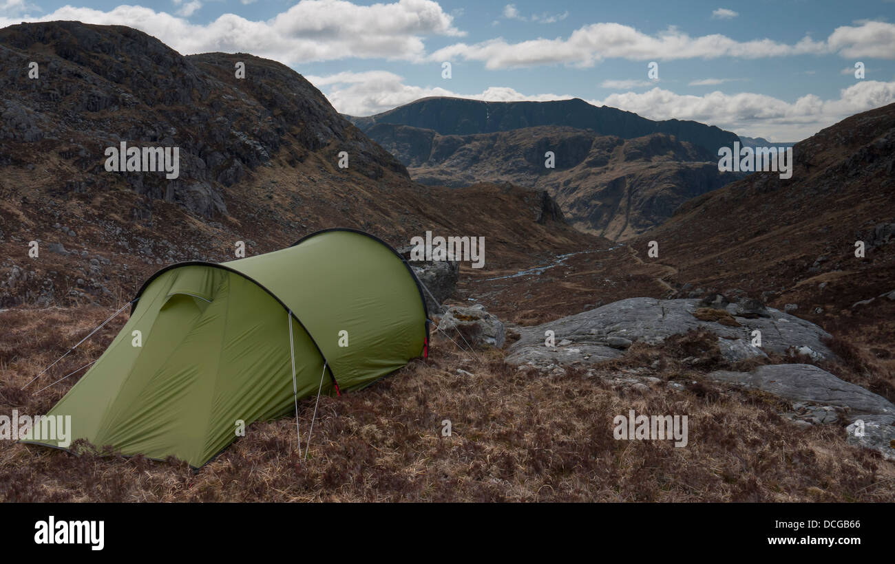 A pitched tent facing SW towards the mountain Beinn Lair in the remote Letterewe Forest of Wester Ross, Highland, UK Stock Photo