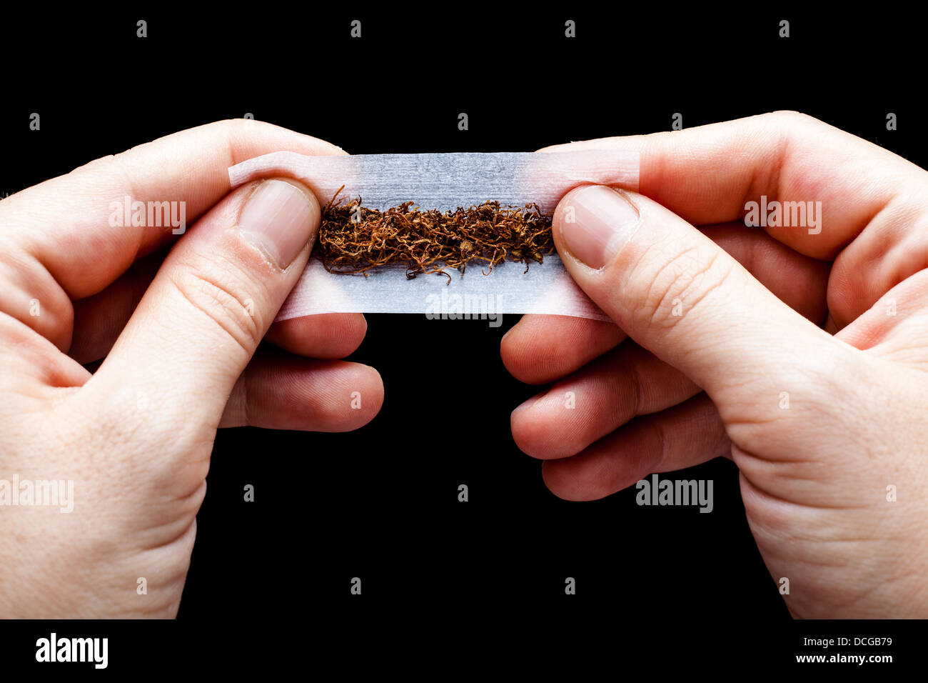 https://c8.alamy.com/comp/DCGB79/hands-rolling-a-cigarette-paper-with-tobacco-DCGB79.jpg