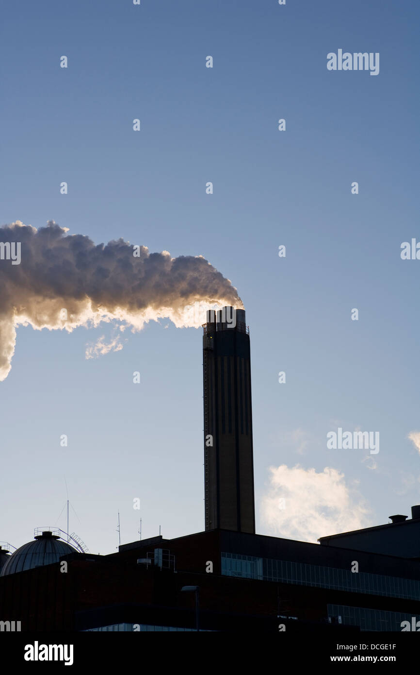 Smoking chimney against a blue sky Stock Photo - Alamy