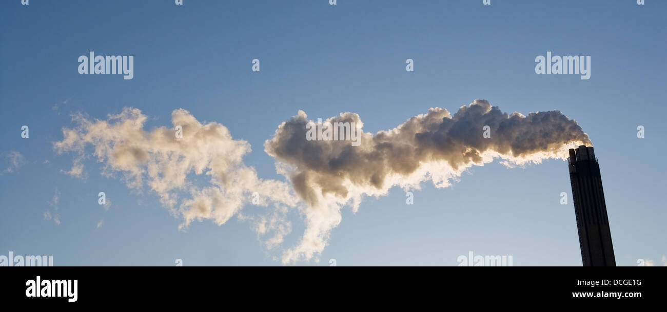 Smoking chimney against a blue sky Stock Photo - Alamy