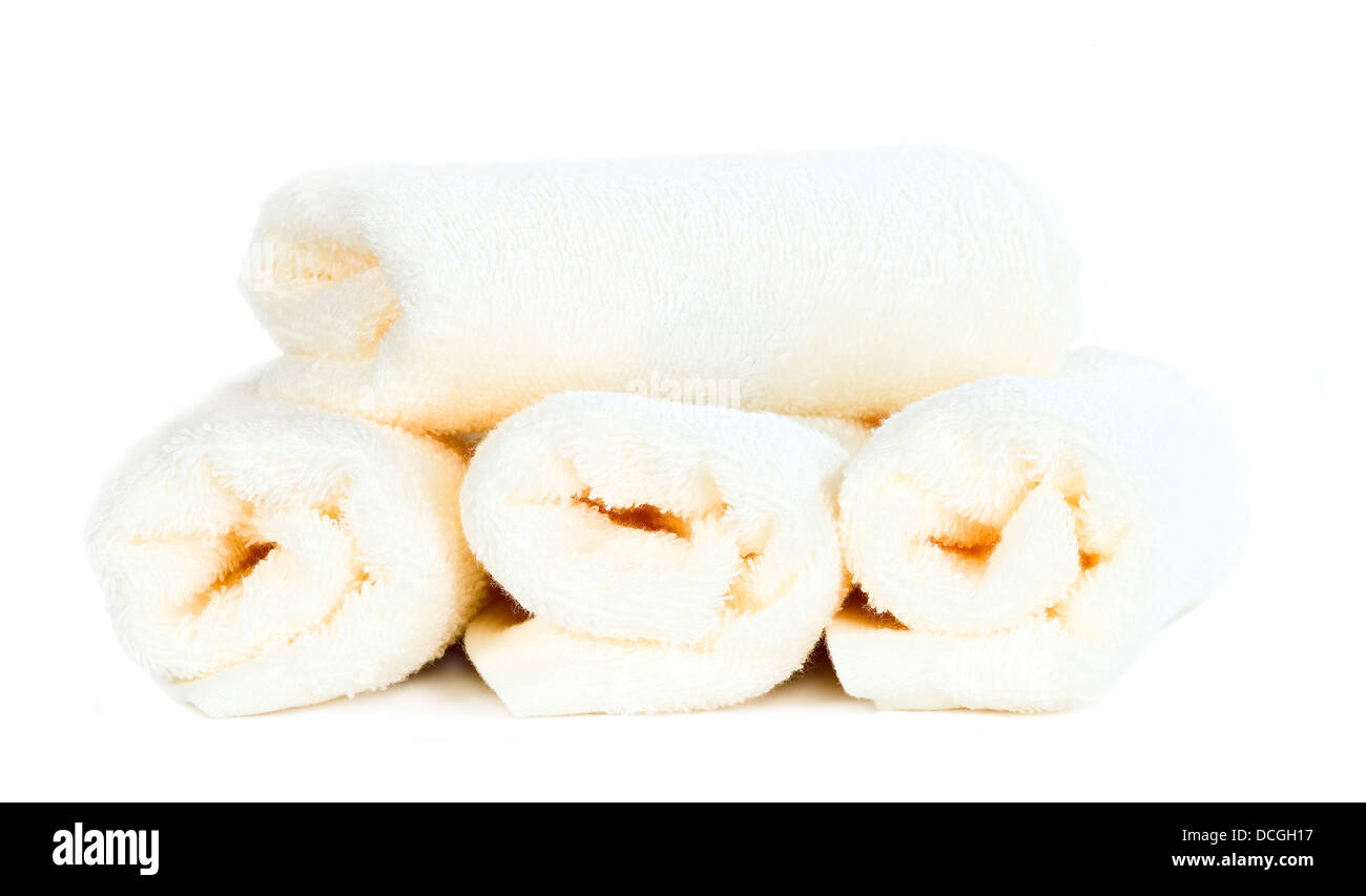 Rolled up white towels on isolated background Stock Photo