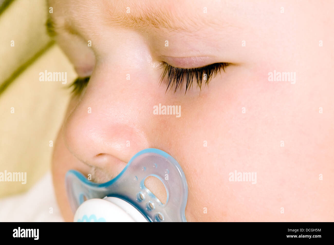 Baby boy is sleeping and sucking soother Stock Photo Alamy