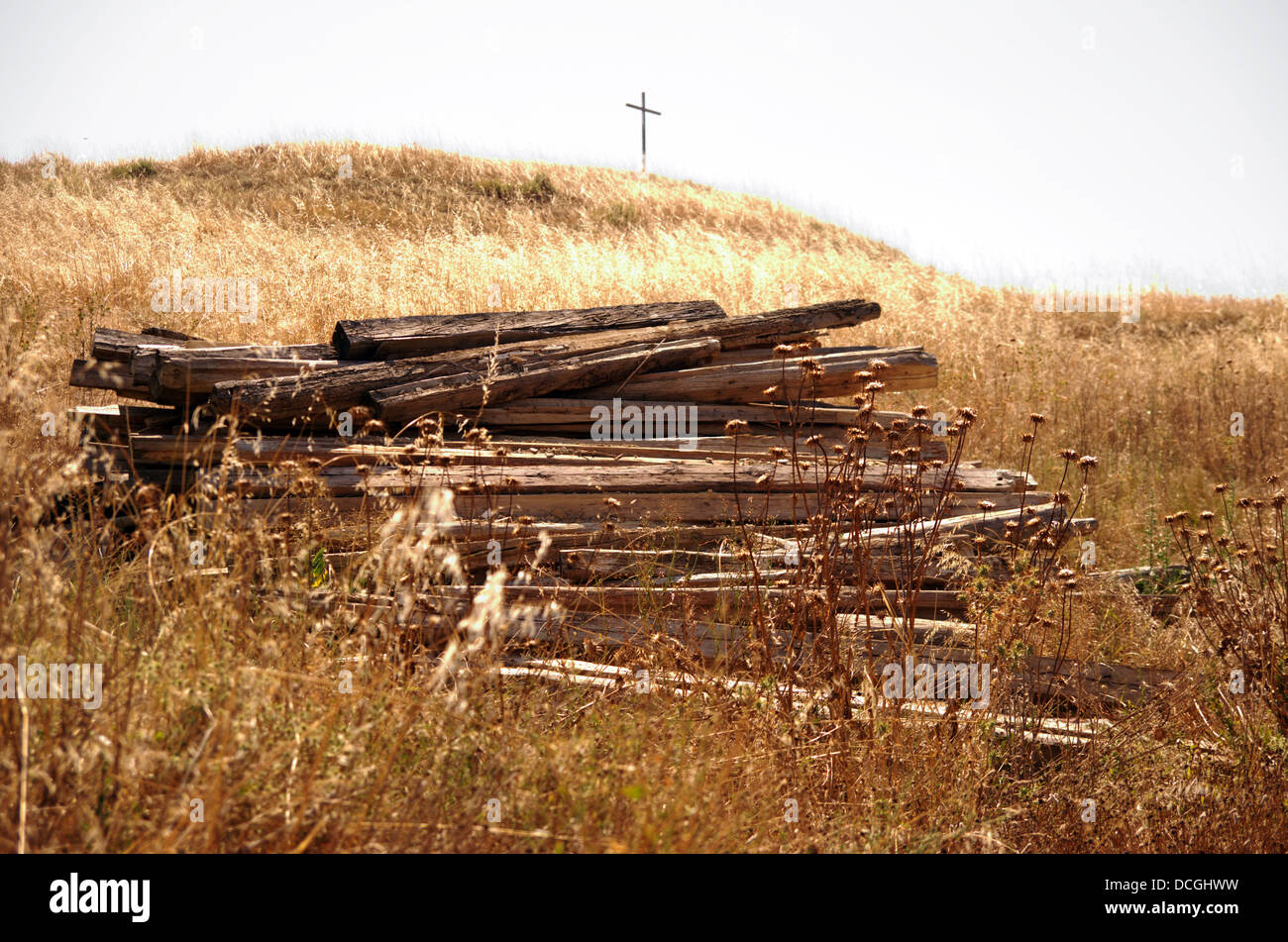 The pile of planks and the cross invites to recover faith in a desolate place Stock Photo