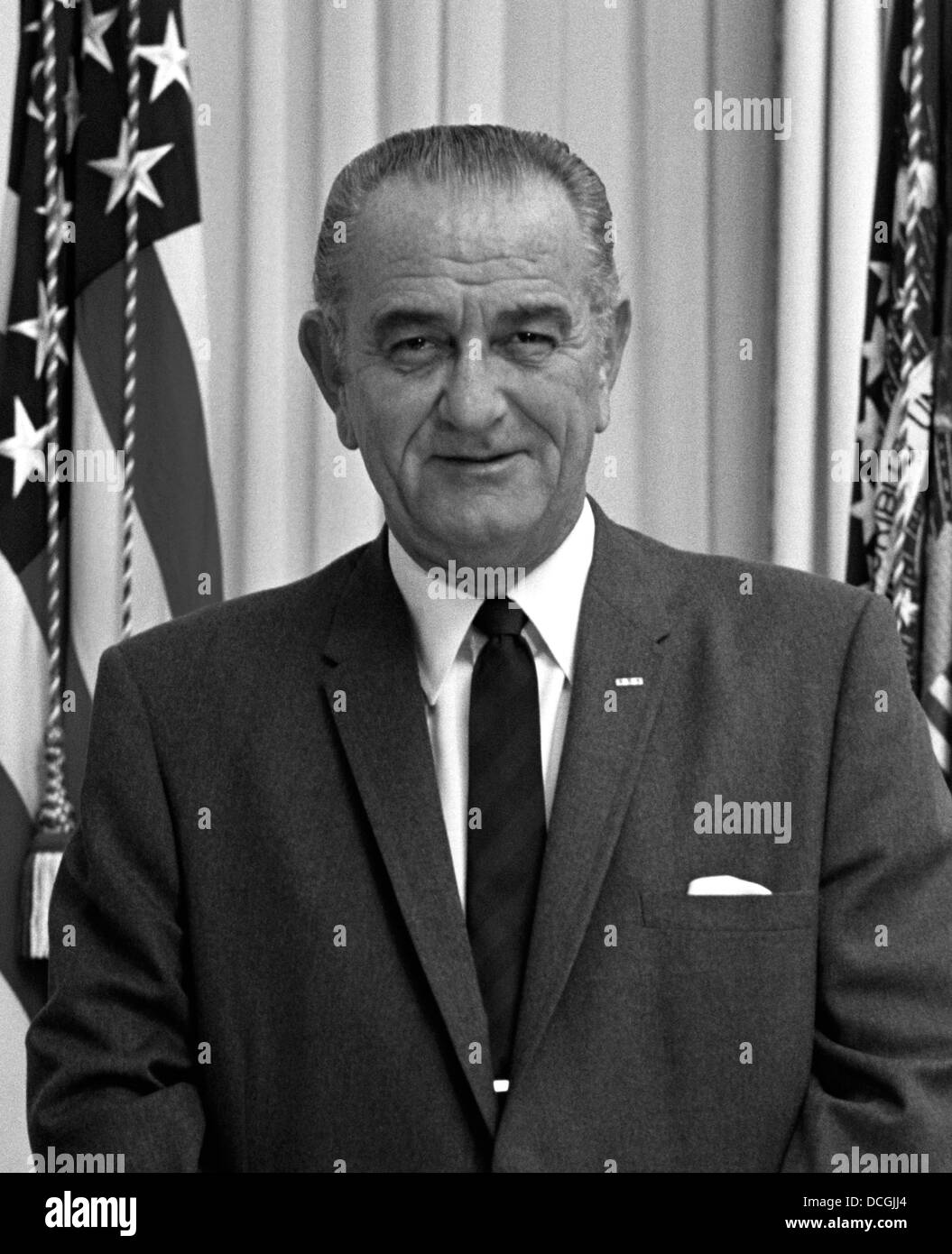 Digitally restored American history photo of President Lyndon Baines Johnson standing by the U.S. Flag. Stock Photo