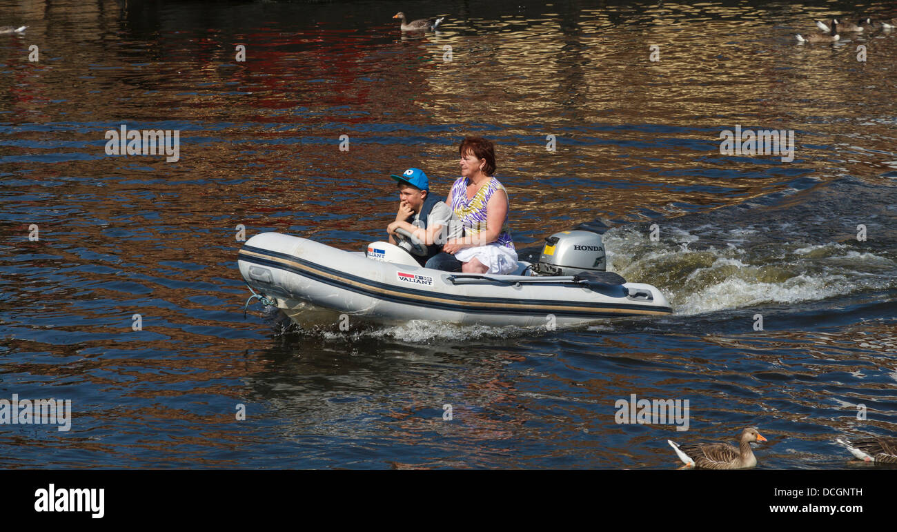 A mother and son taking a boat trip on the River Ouse, York City, Yorkshire, England Stock Photo