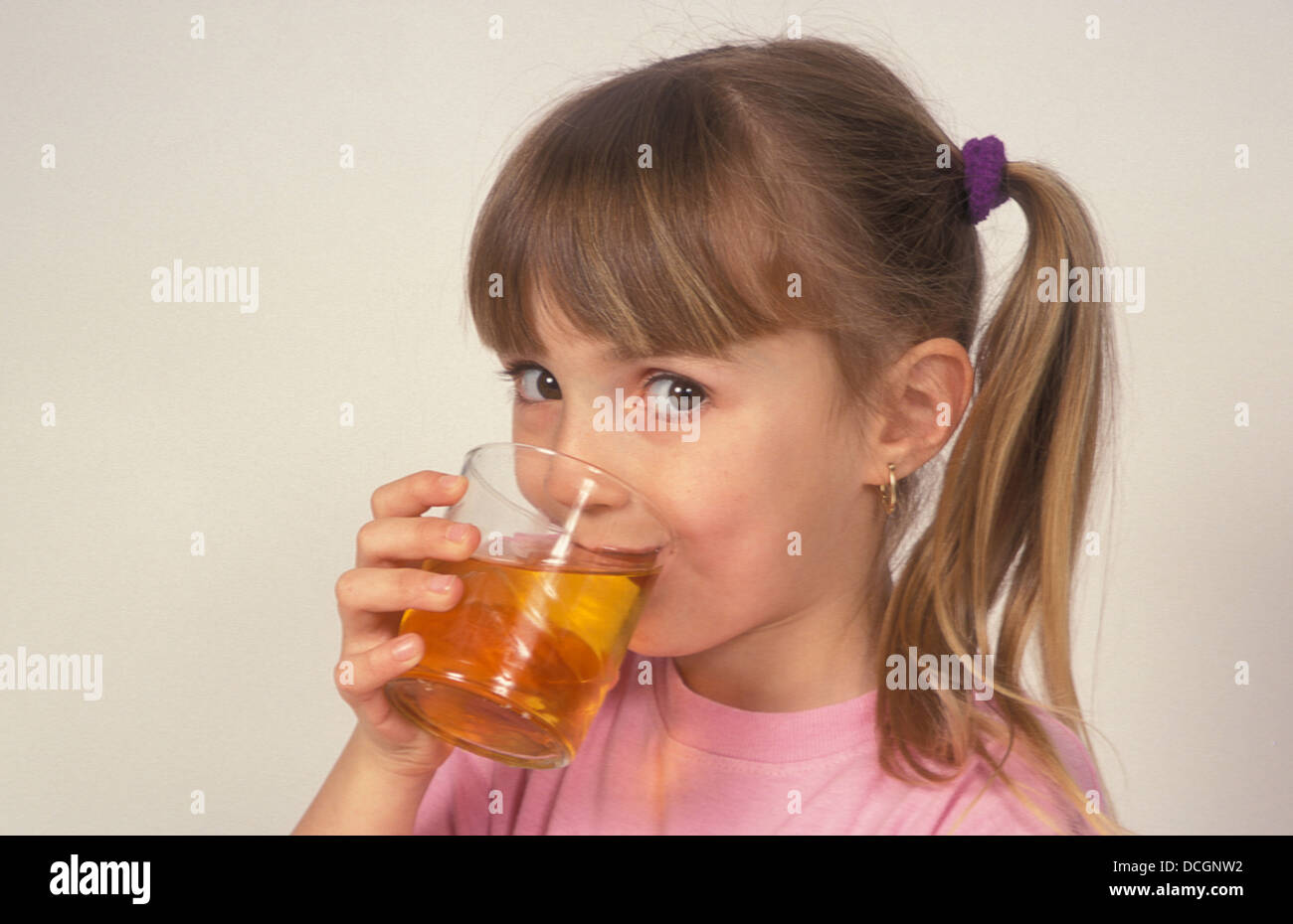 young-girl-drinking-apple-juice-DCGNW2.jpg