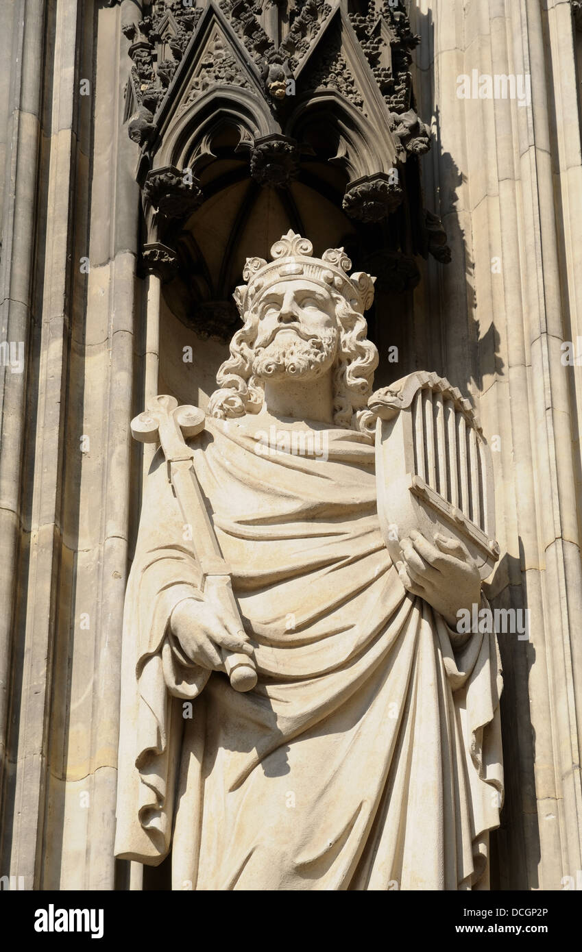 Gothic statue from external wall of Cologne cathedral in sunny day Stock Photo