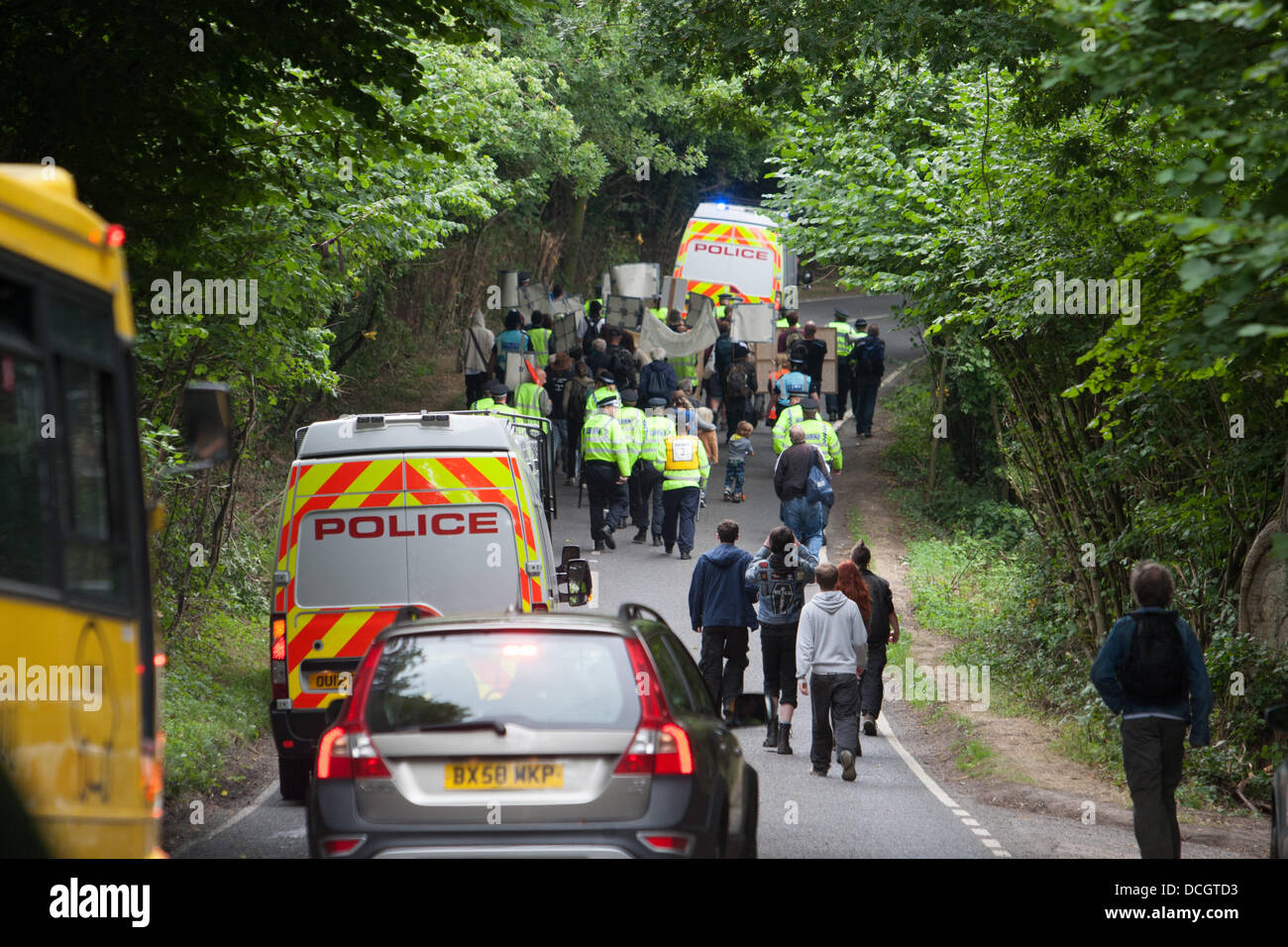 Balcombe, West Sussex, UK. 17th Aug, 2013. Protesters against Cuadrilla drilling & fracking just outside the village of Balcombe are escorted by police towards the protest site on the London Road. Credit:  martyn wheatley/Alamy Live News Stock Photo