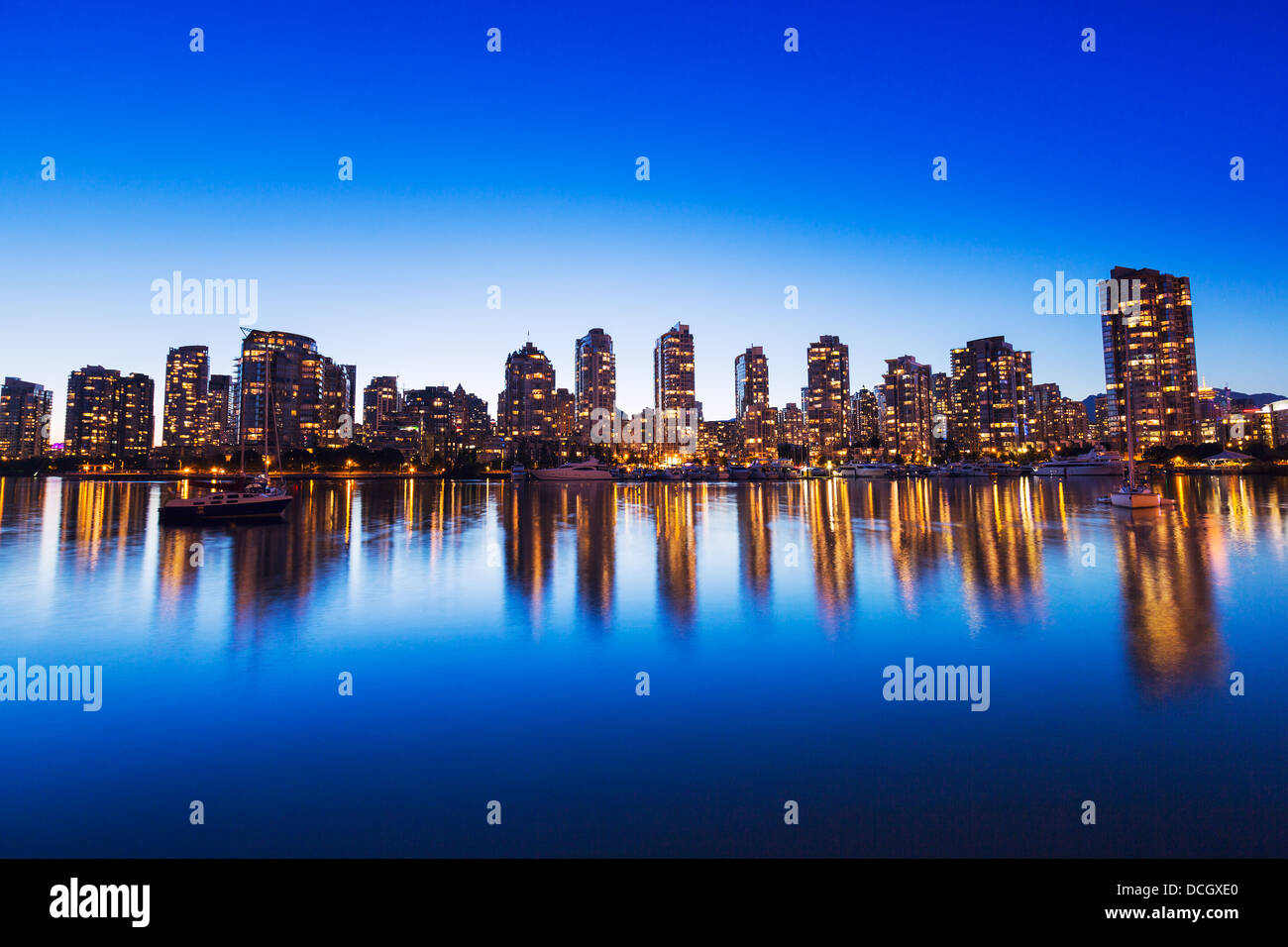 Modern Urban City Skyline Reflecting in Water at Sunset, Vancouver Stock Photo