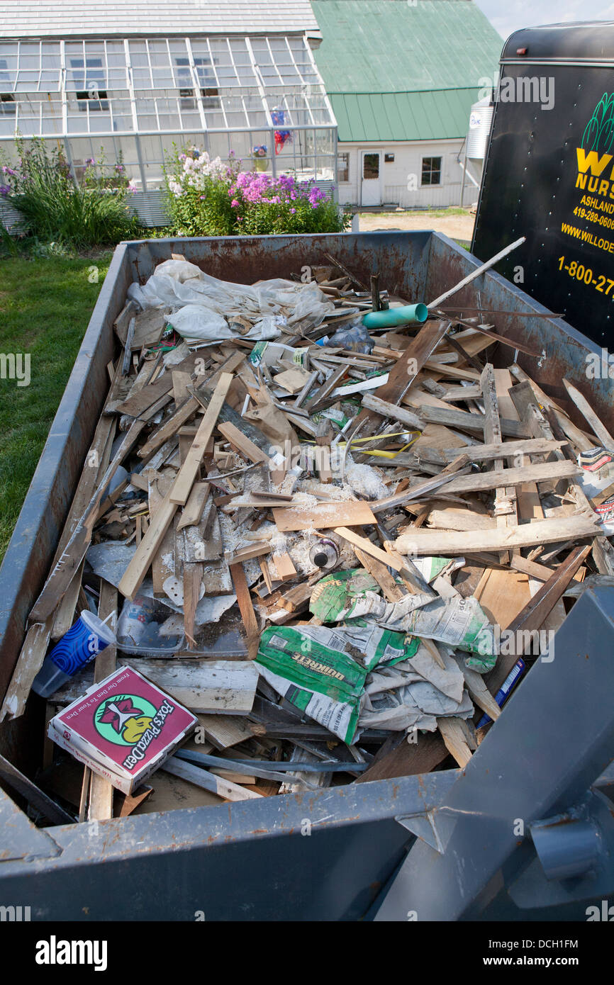 Trash dumpster filled with construction waste Stock Photo Alamy