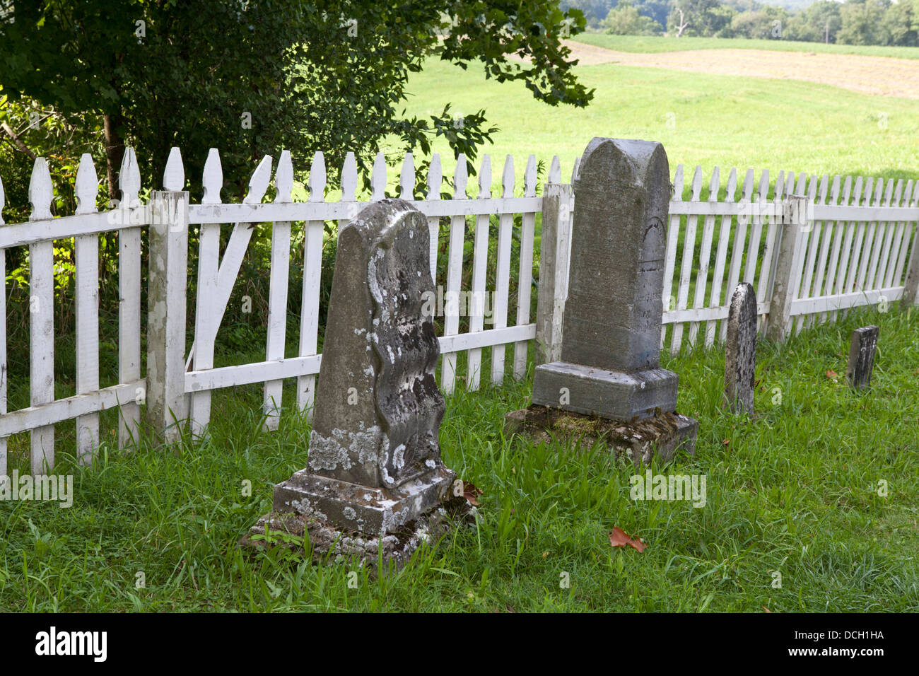 Grave markers with white picket fence in the background (Malabar Historic Farm State Park, Ohio) Stock Photo