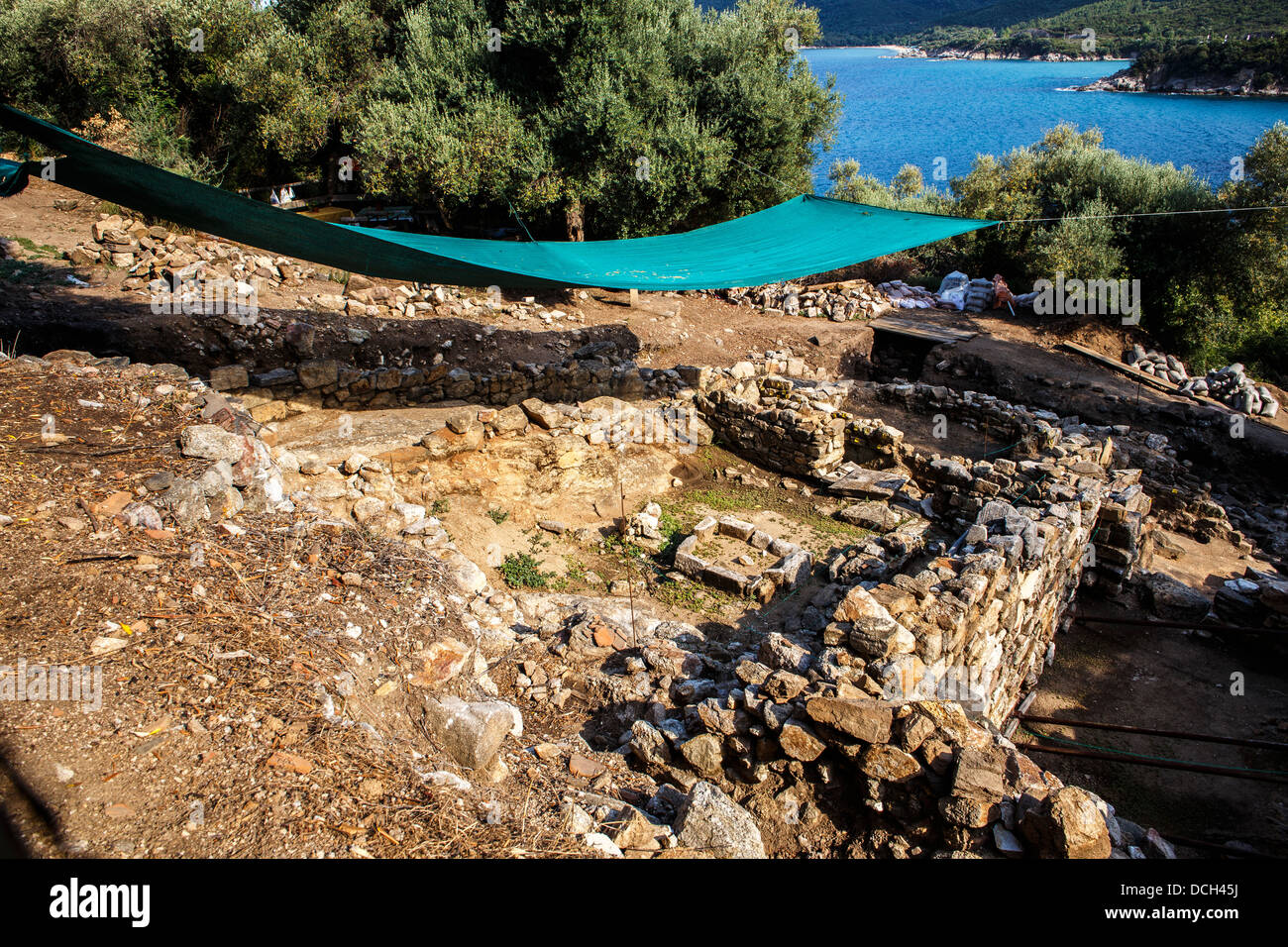 Archaeological excavation site covered by tarp with the sea in the background Stock Photo