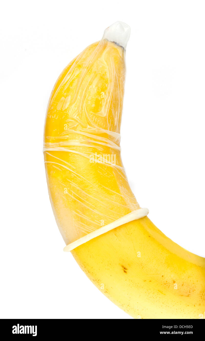 Condom (preservative) is on banana. Concept of importance of protection while having sex. Stock Photo