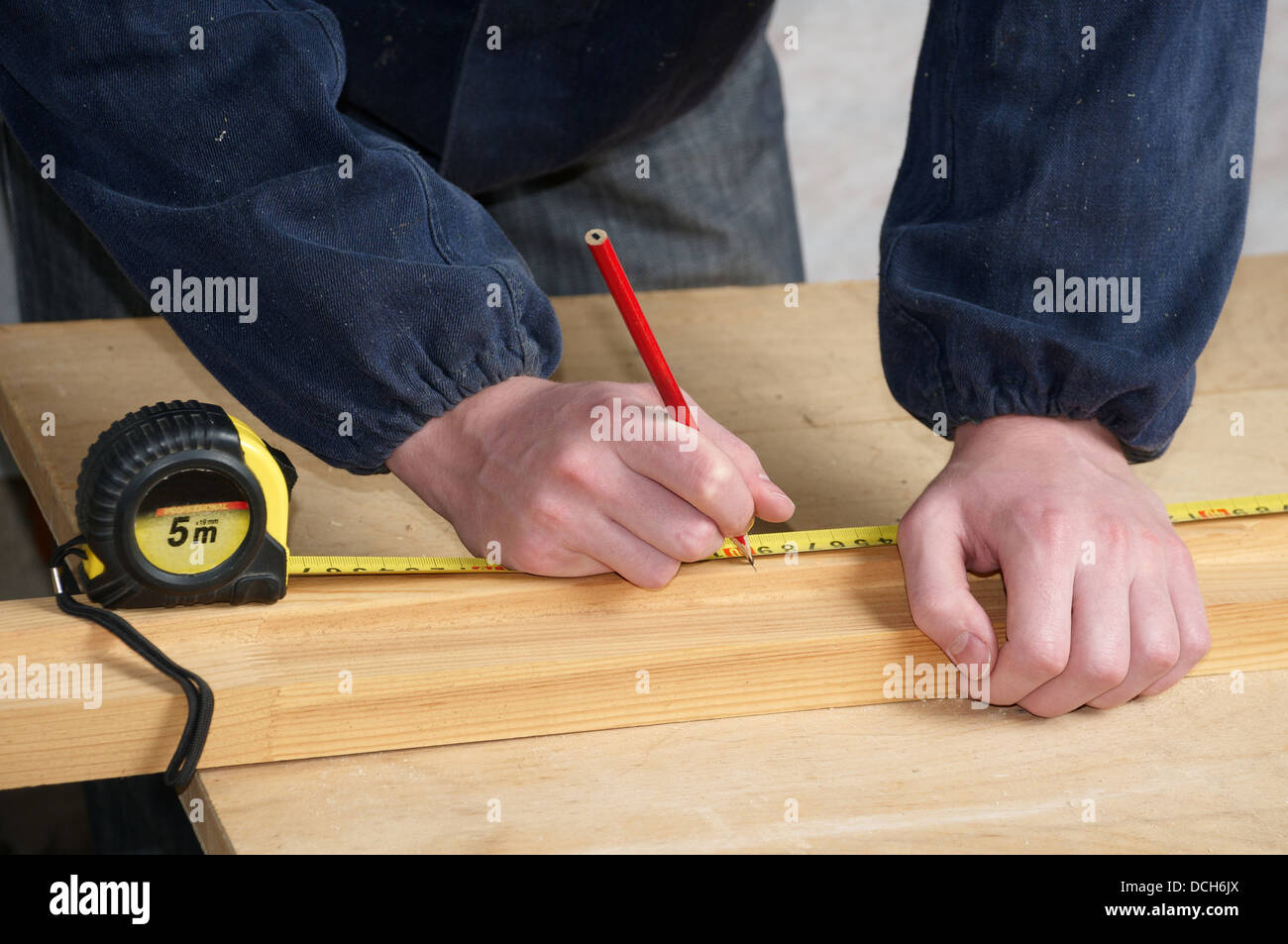 The worker measures the distance and puts a mark Stock Photo Alamy