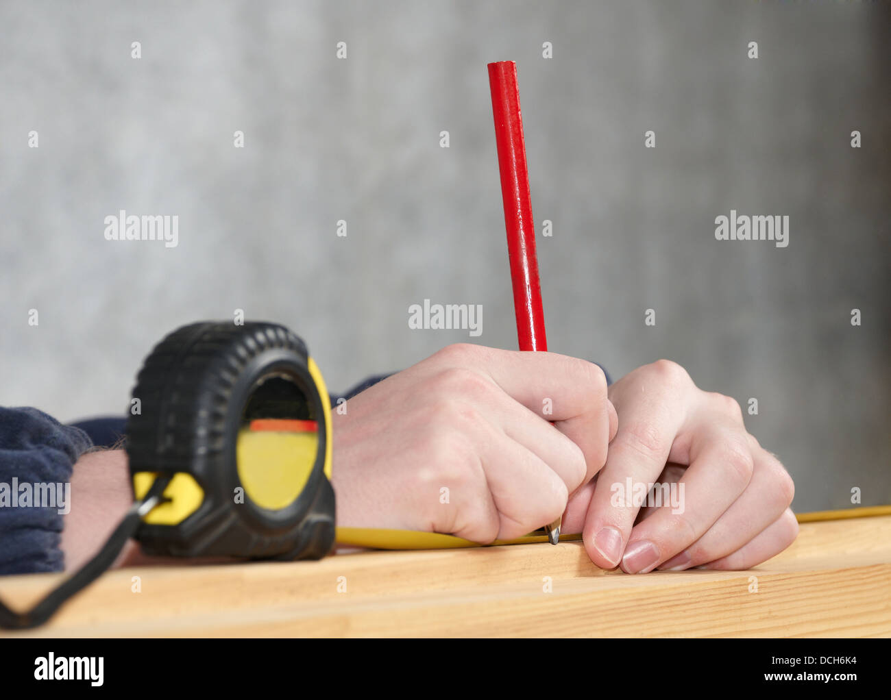 Worker measures distance and puts a mark Stock Photo Alamy